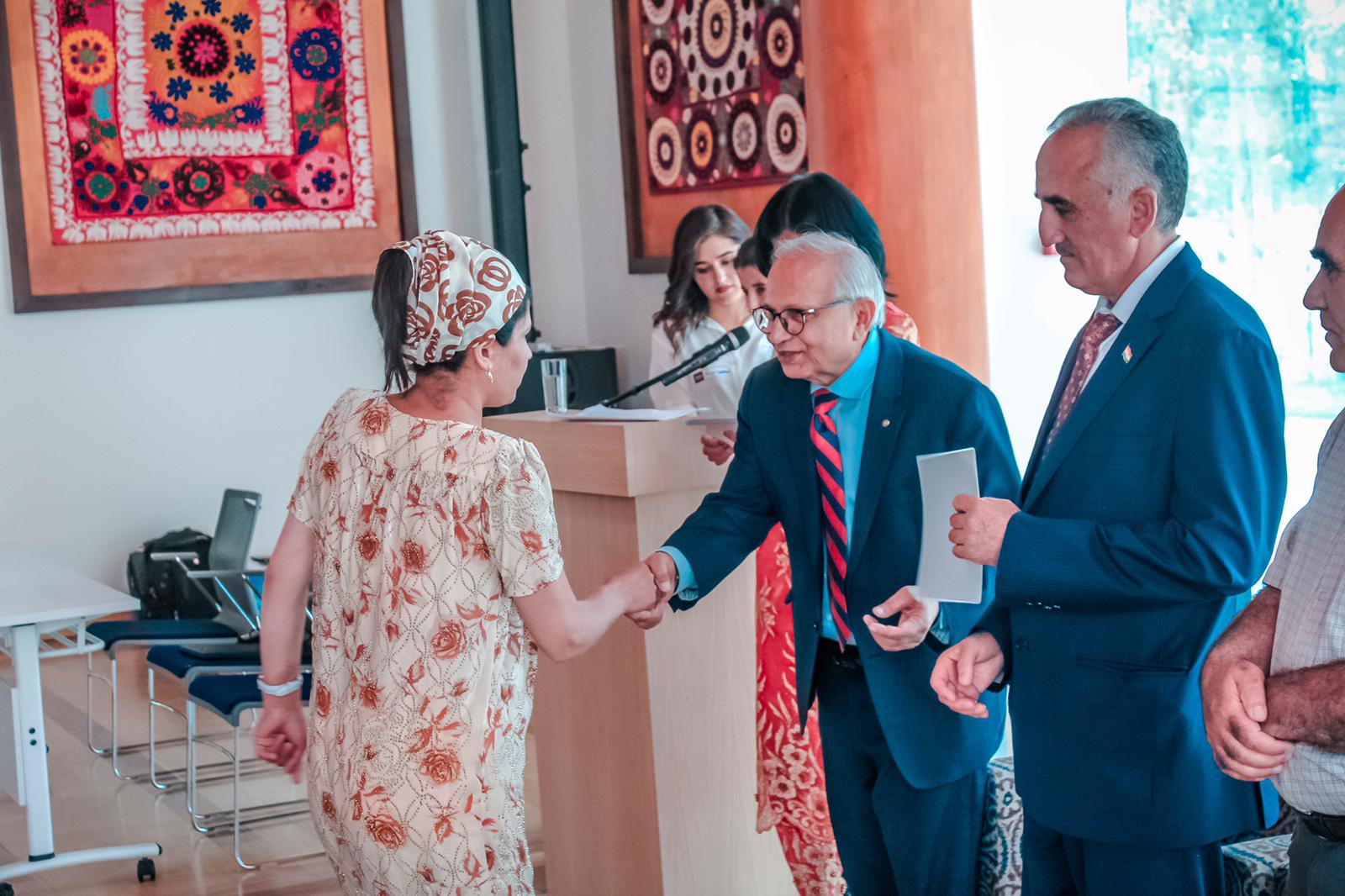 Head of FBLUSA giving certificate to a beneficiary