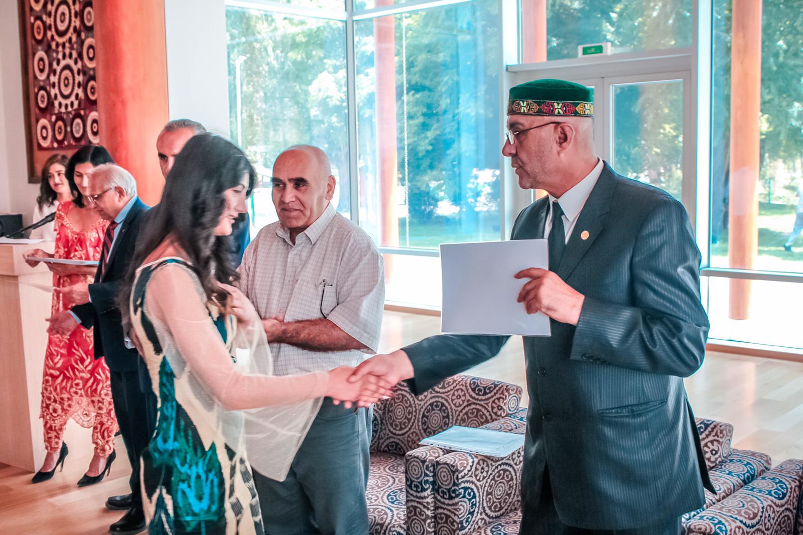 Director of FBLT giving certificate to a beneficiary